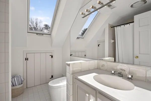 a living room with furniture a flat screen tv and a floor to ceiling window