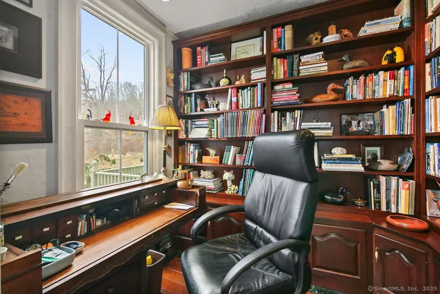 a room with furniture book shelf and a window