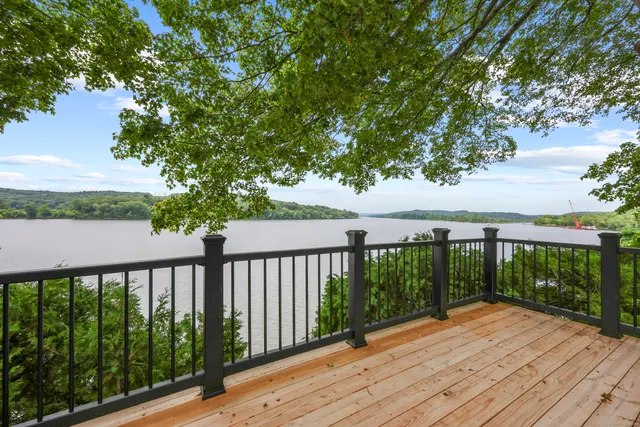 a balcony with wooden floor and fence