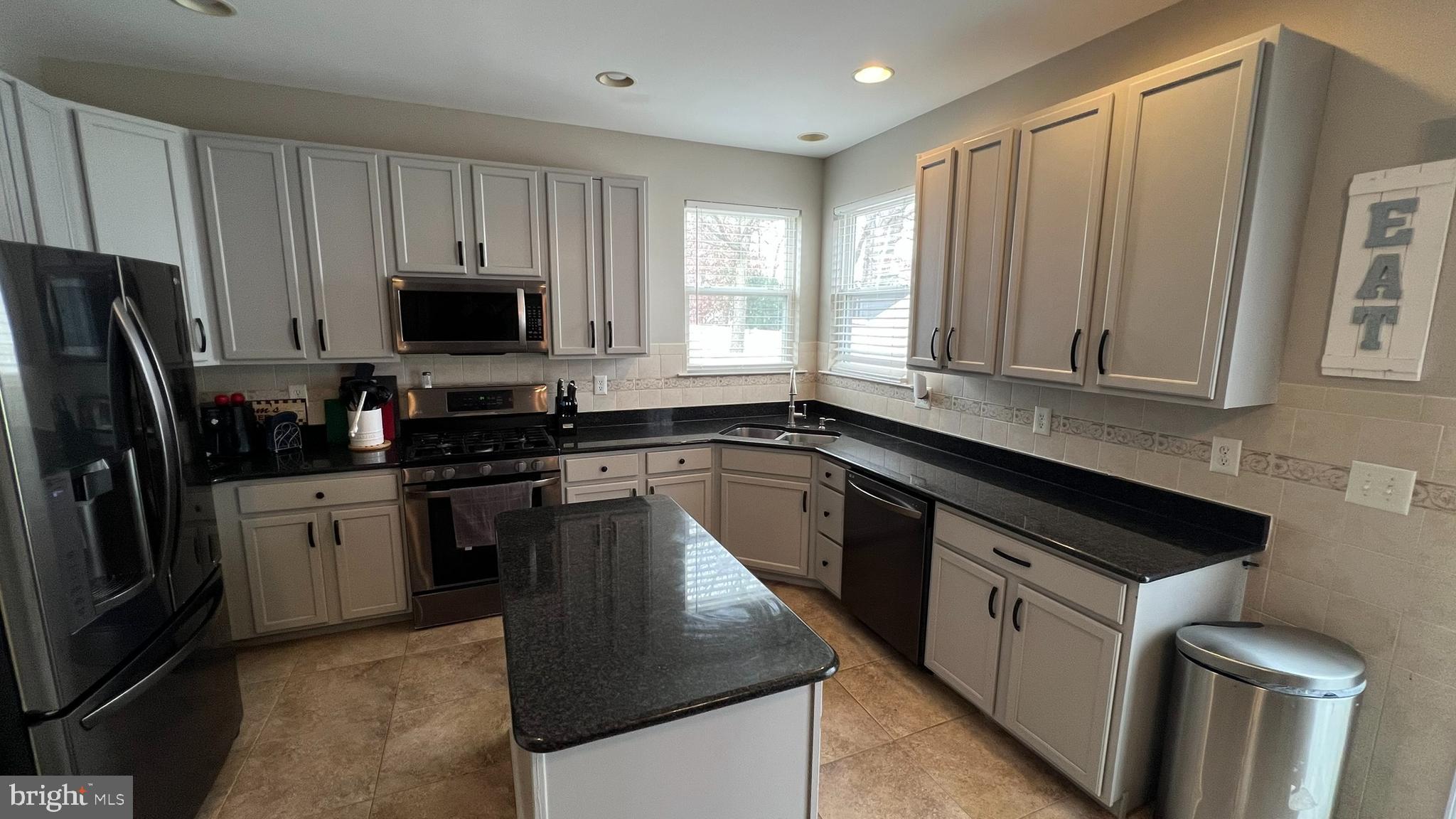 415 Stockton Loop Williamstown, NJ 08094 - Photo 14 of 41 a kitchen with stainless steel appliances granite countertop a stove a sink dishwasher a refrigerator and a microwave