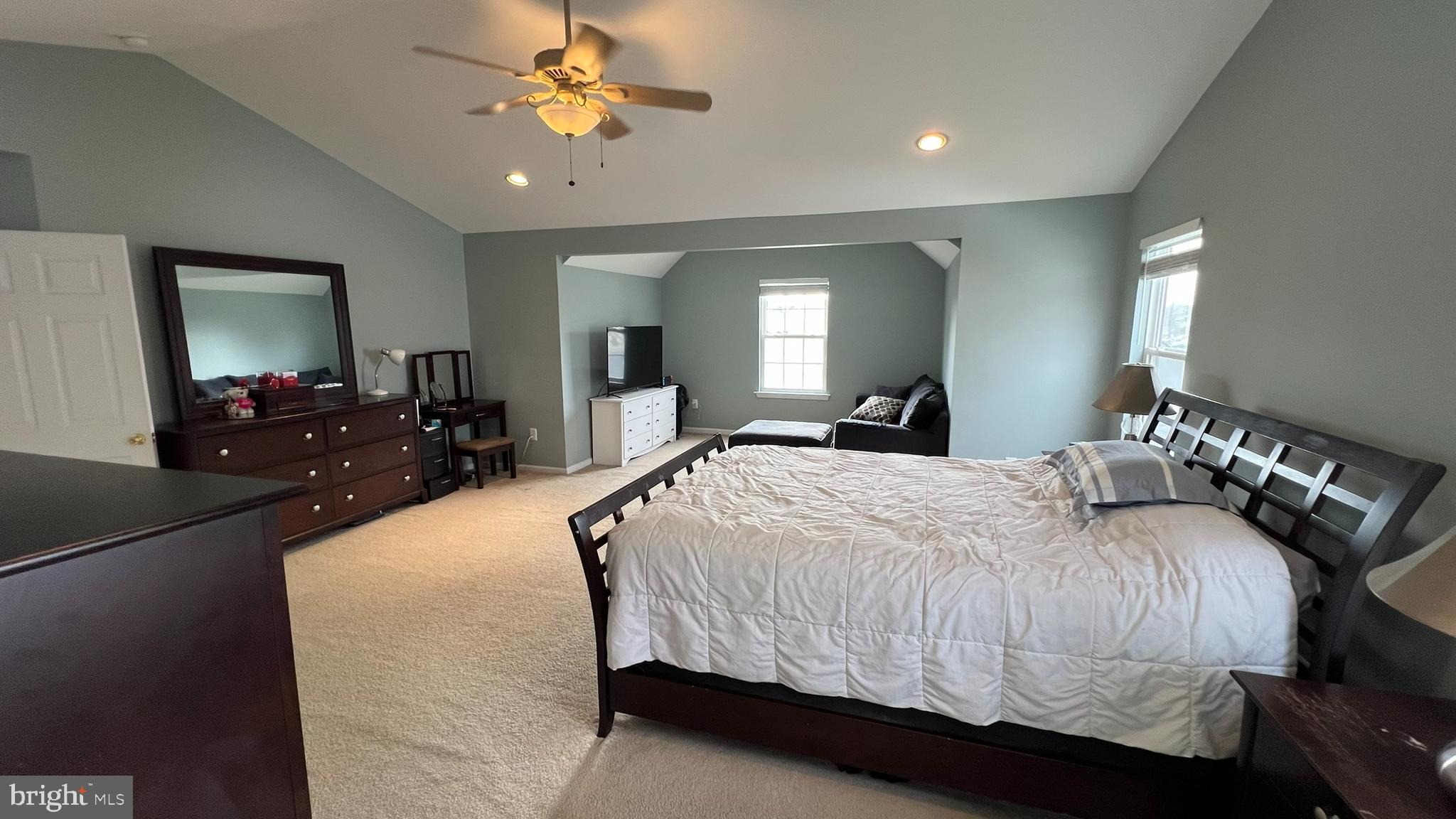 415 Stockton Loop Williamstown, NJ 08094 - Photo 30 of 41 a bedroom with a large bed and a chandelier