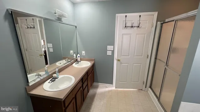 a bathroom with a sink a mirror a washer and dryer