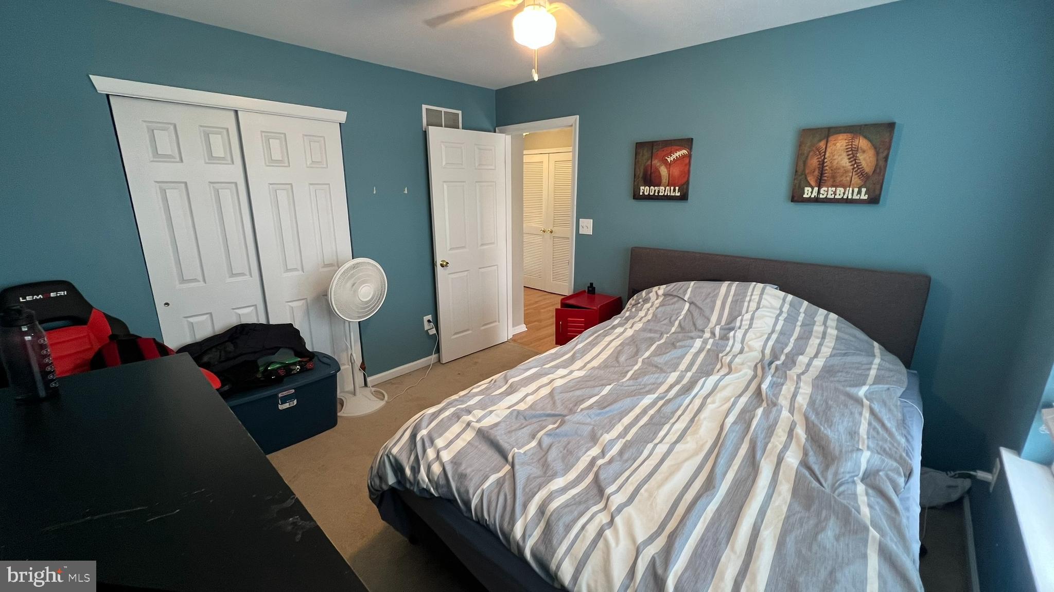 415 Stockton Loop Williamstown, NJ 08094 - Photo 38 of 41 a bedroom with a bed and a chandelier