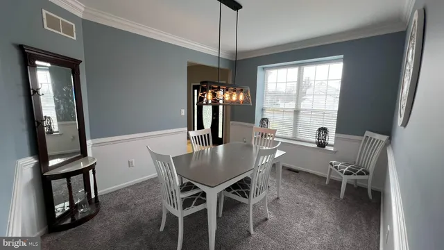 a view of a dining room with furniture and window