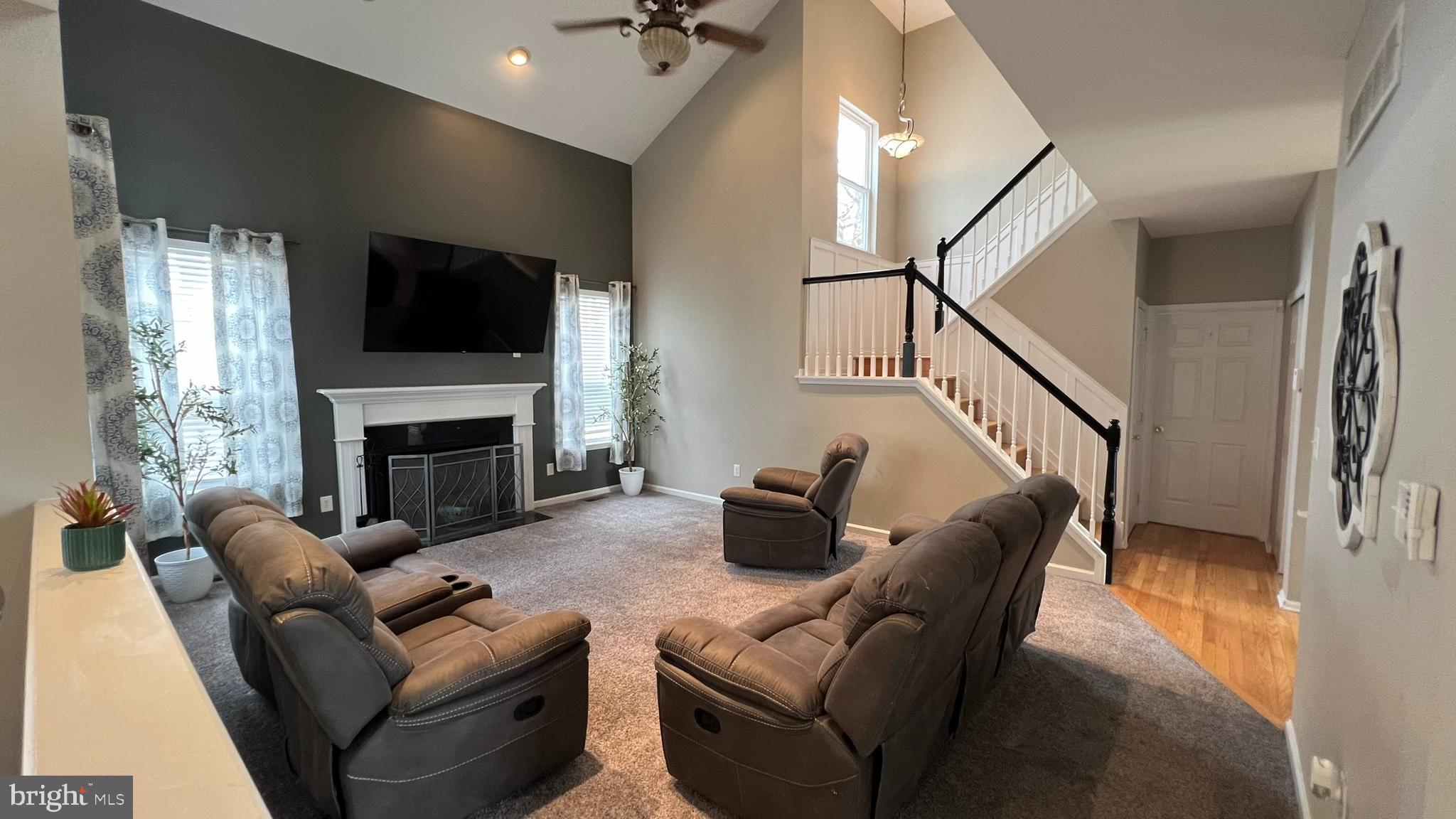 415 Stockton Loop Williamstown, NJ 08094 - Photo 7 of 41 a living room with furniture a flat screen tv and a fireplace