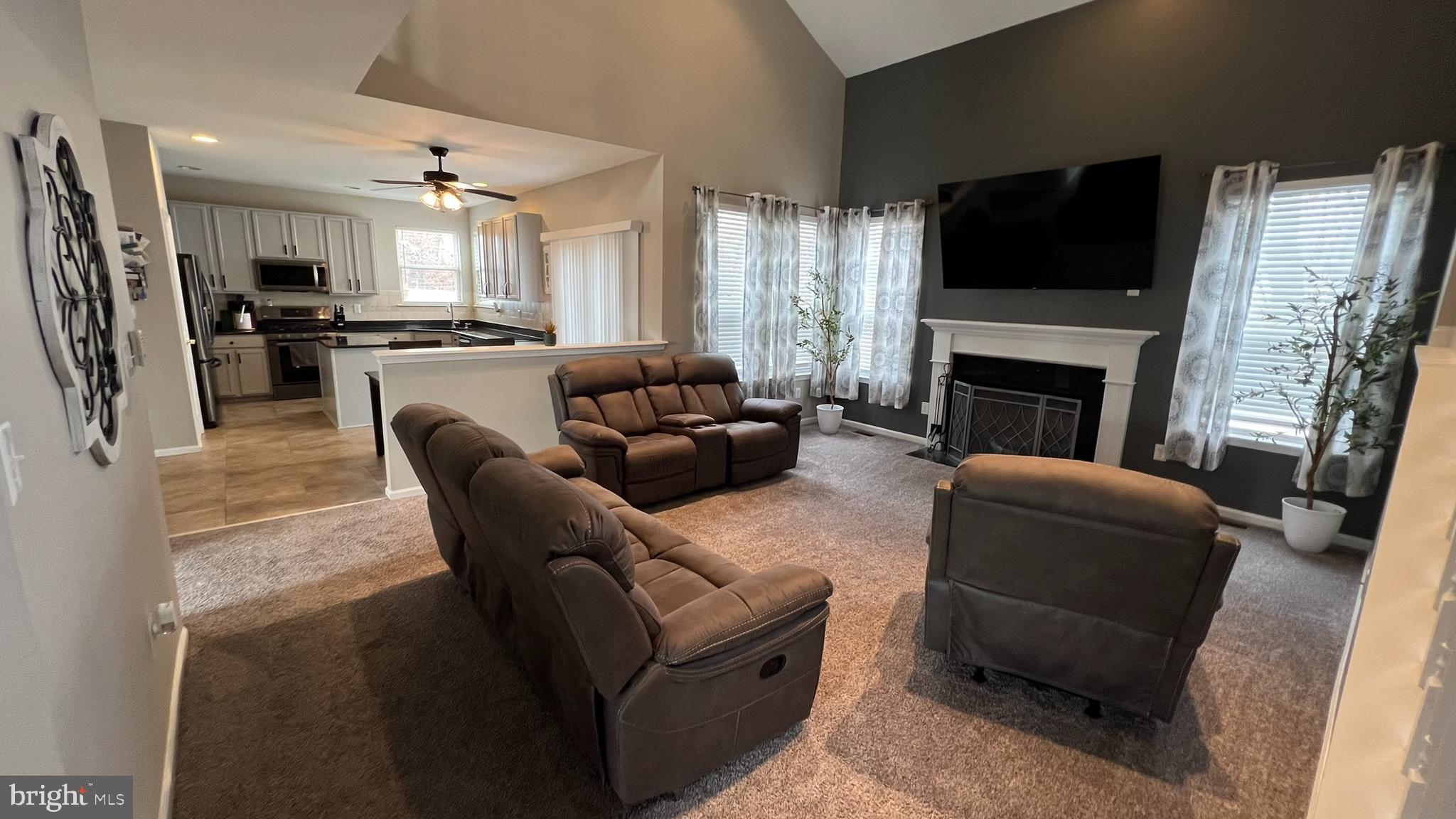 415 Stockton Loop Williamstown, NJ 08094 - Photo 8 of 41 a living room with furniture fireplace and flat screen tv