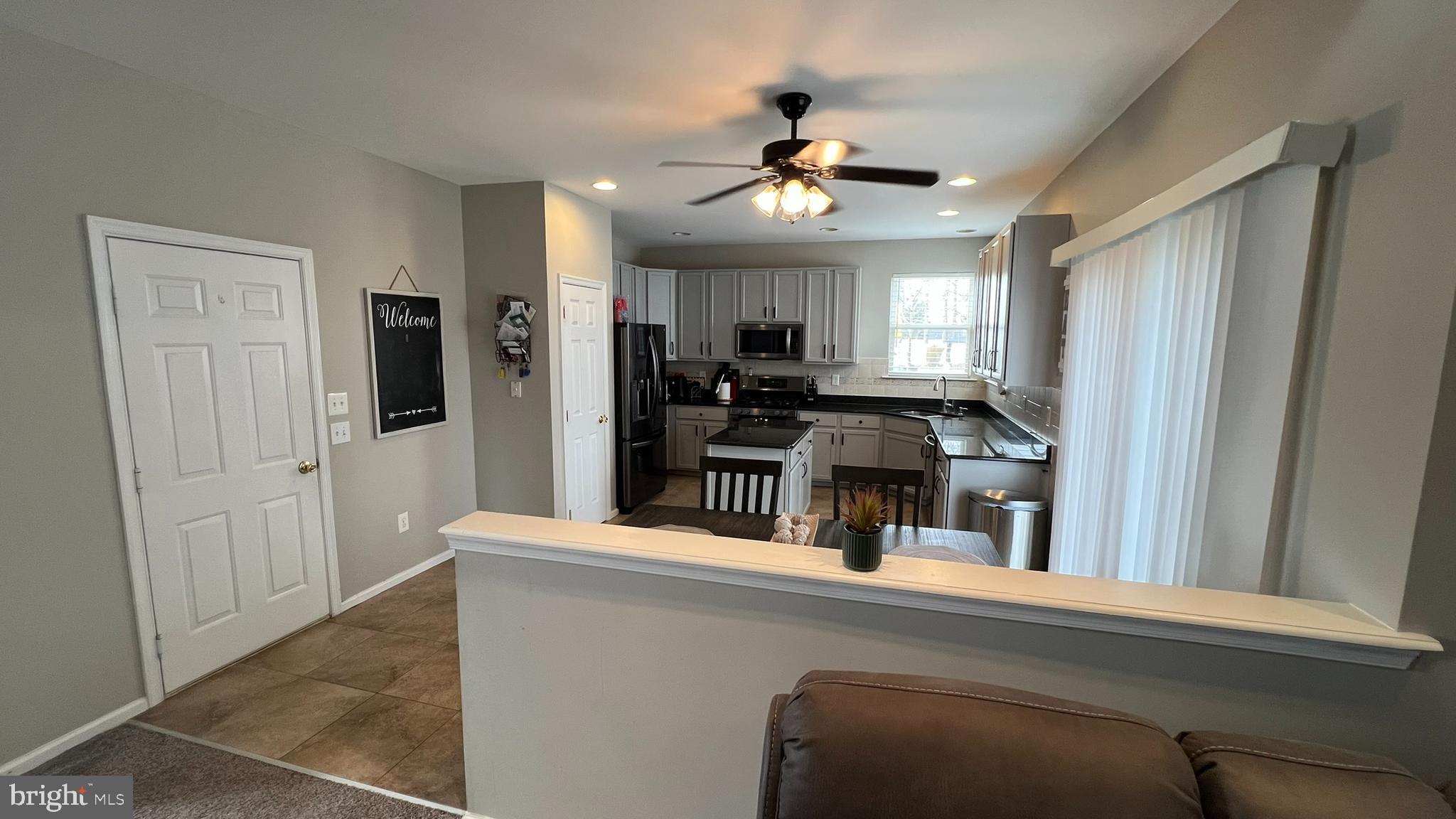 415 Stockton Loop Williamstown, NJ 08094 - Photo 10 of 41 a view of living room with furniture and chandelier