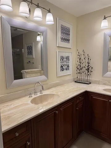 a kitchen with wooden cabinets and black appliances