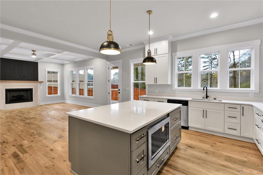 3369 Dodson Drive Connector East Point, GA 30344 - Photo 11 of 43 a kitchen with a stove center island a sink cabinets and a wooden floor
