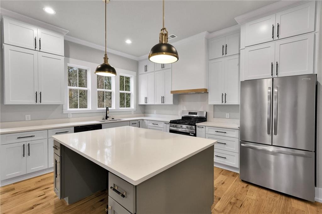 3369 Dodson Drive Connector East Point, GA 30344 - Photo 15 of 43 a kitchen with a center island a stove a refrigerator cabinets and a center island