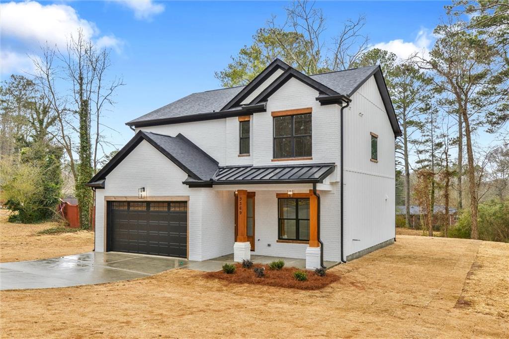 3369 Dodson Drive Connector East Point, GA 30344 - Photo 2 of 43 a front view of a house with a yard and garage