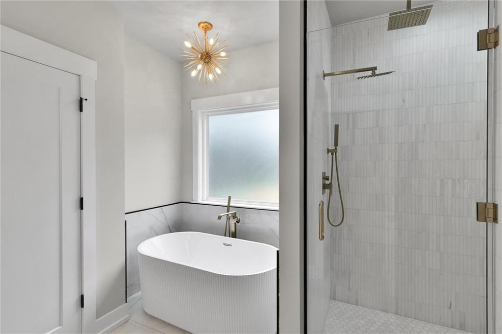 3369 Dodson Drive Connector East Point, GA 30344 - Photo 27 of 43 a bathroom with a sink a mirror and a shower