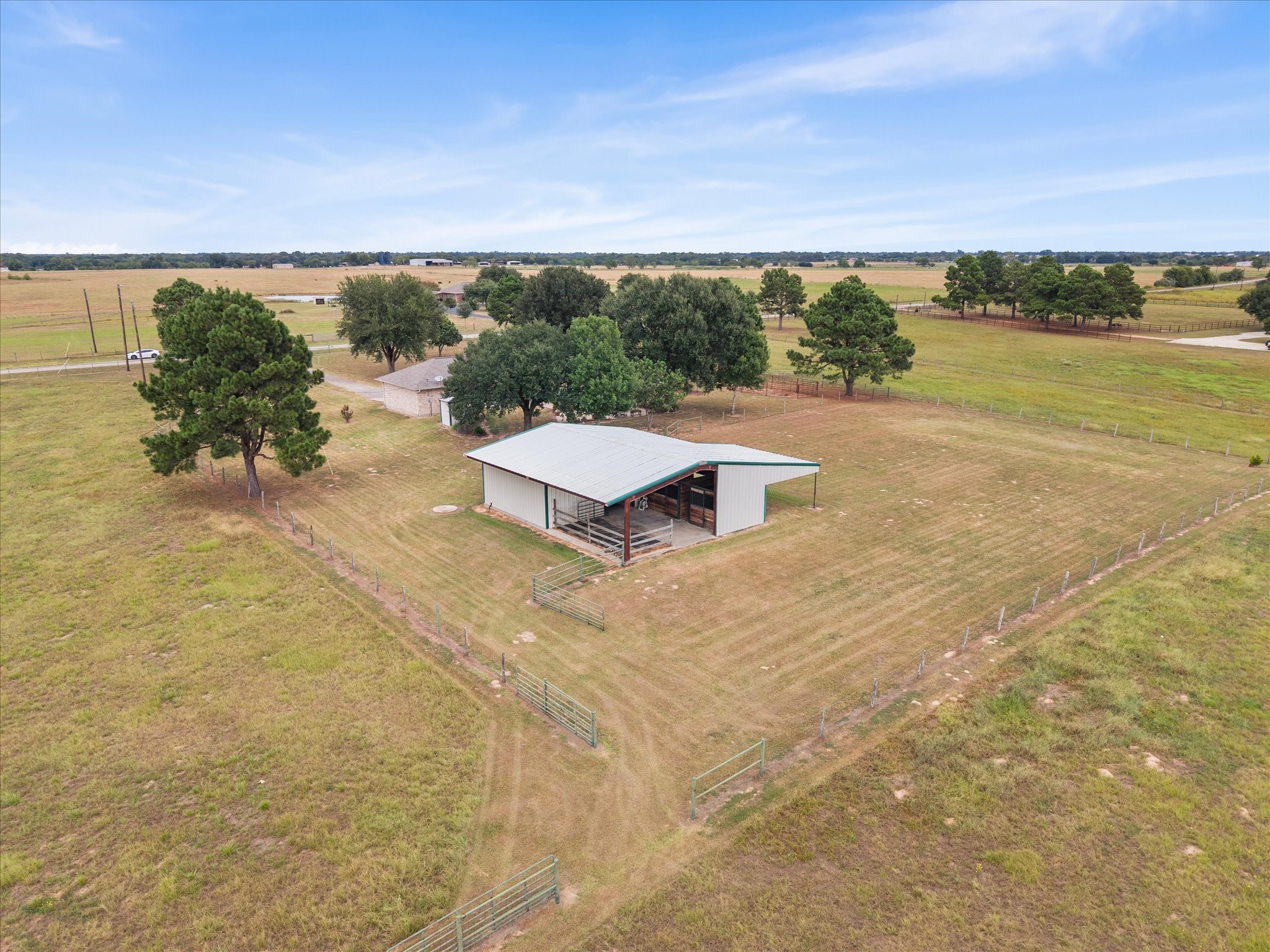 19929 Pierceall Road Hempstead, TX 77445 - Photo 47 of 50 With 10.5 fully fenced acres, a well-appointed barn and stables, separate corral, private well, inviting home, and peaceful Pine Island setting, this is a rare opportunity to embrace the space and freedom of country living.