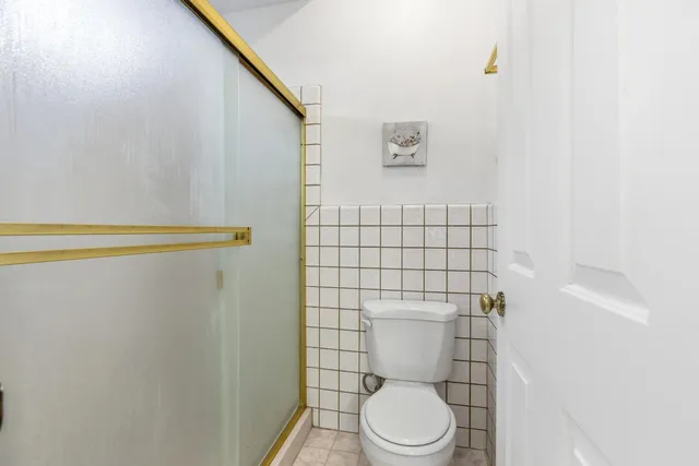 a bathroom with a toilet and a shower curtain