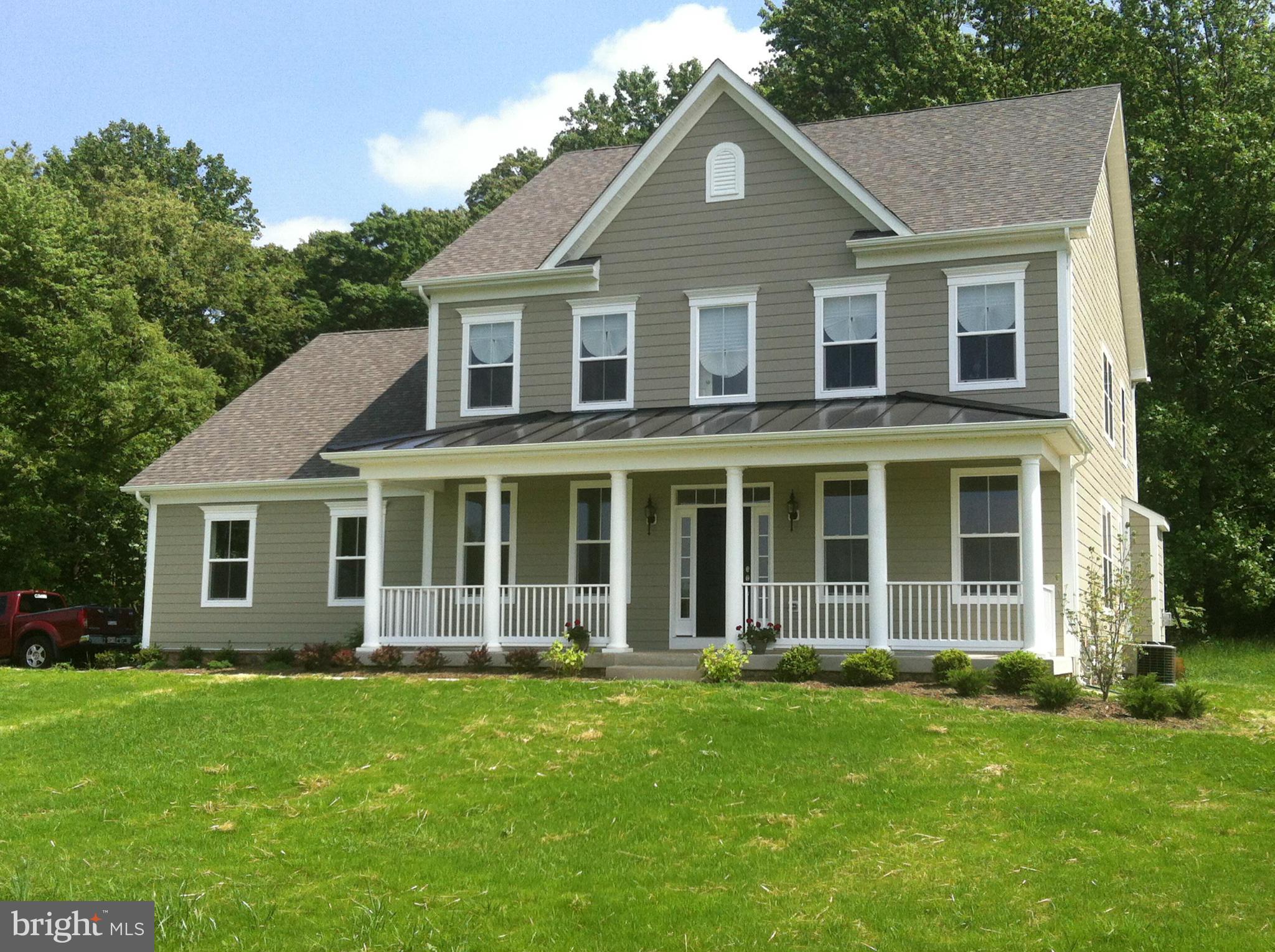 Full front porch w/ metal roof and brick to grade