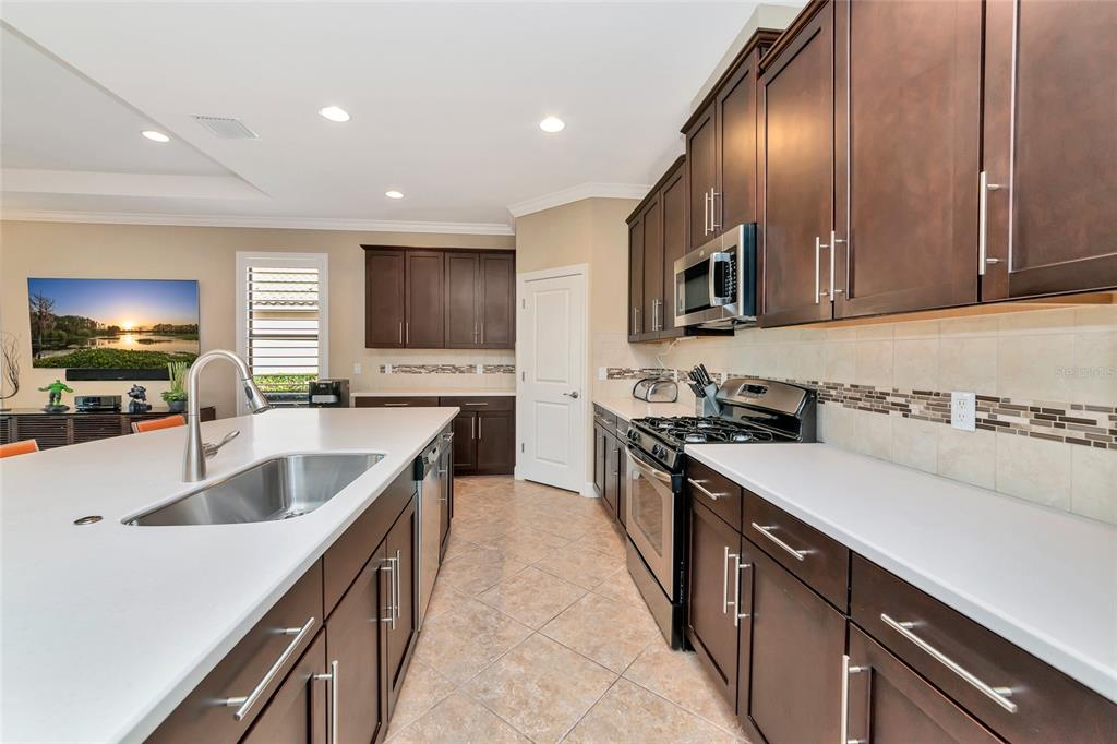 12848 Del Corso Loop Lakewood Ranch, FL 34211 - Photo 13 of 70 a kitchen with stainless steel appliances granite countertop a sink stove and refrigerator