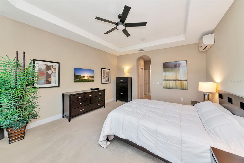 12848 Del Corso Loop Lakewood Ranch, FL 34211 - Photo 24 of 70 a spacious bedroom with a bed and a ceiling fan