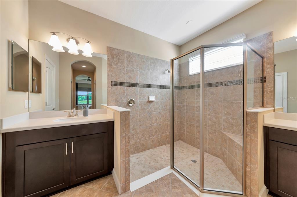 12848 Del Corso Loop Lakewood Ranch, FL 34211 - Photo 26 of 70 a bathroom with a double vanity sink mirror and shower