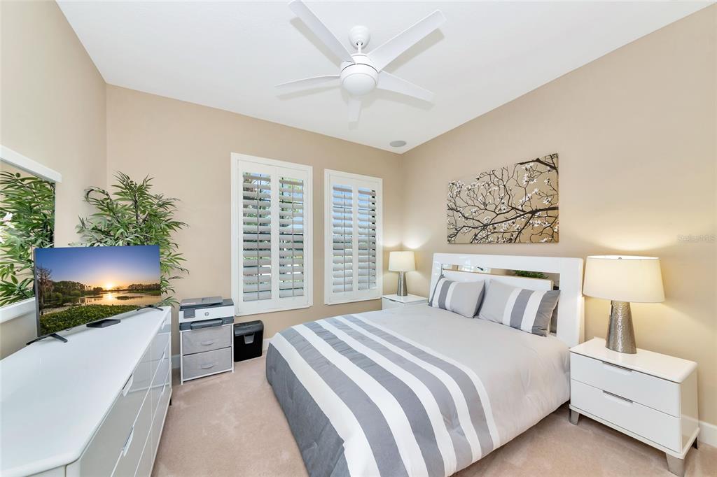 12848 Del Corso Loop Lakewood Ranch, FL 34211 - Photo 29 of 70 a bedroom with a large bed and a flat screen tv