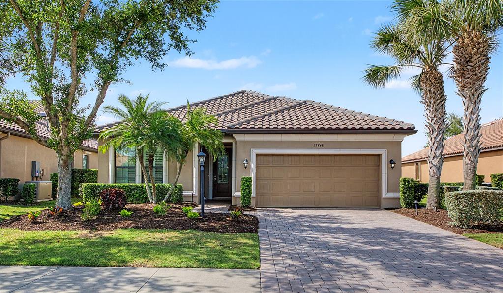 12848 Del Corso Loop Lakewood Ranch, FL 34211 - Photo 40 of 70 a front view of a house with garden