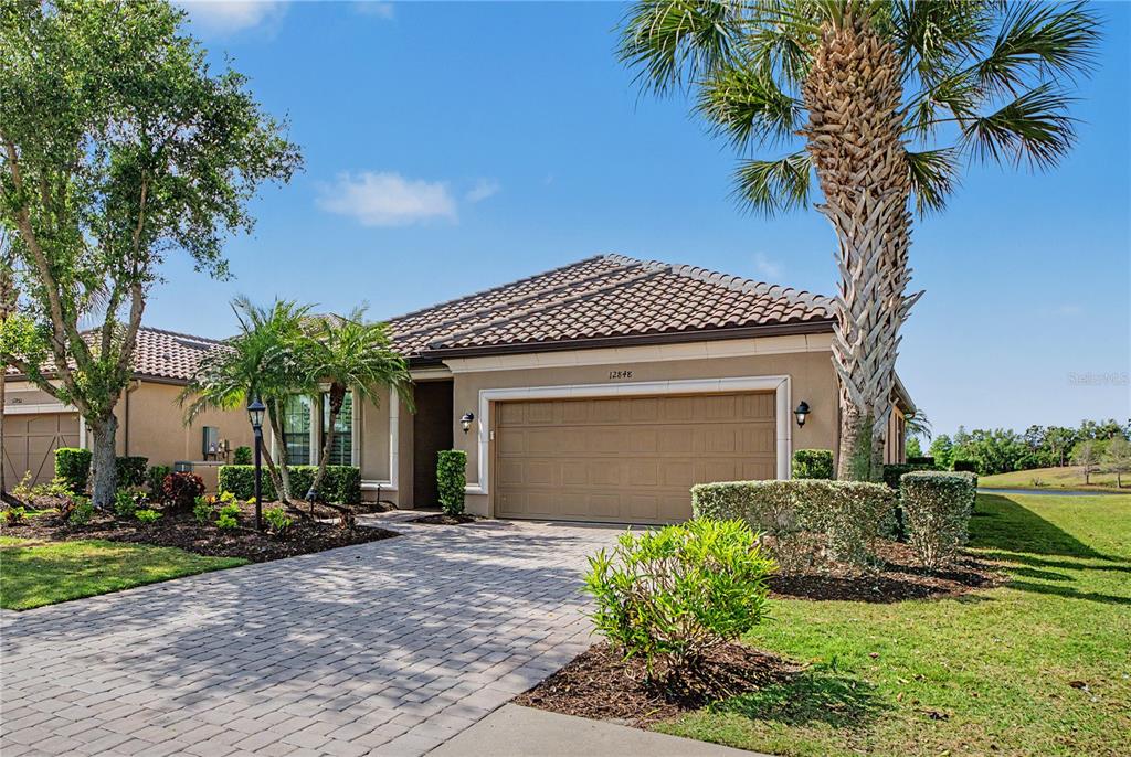 12848 Del Corso Loop Lakewood Ranch, FL 34211 - Photo 41 of 70 a front view of a house with a yard