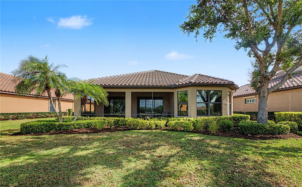 12848 Del Corso Loop Lakewood Ranch, FL 34211 - Photo 44 of 70 a front view of a house with garden