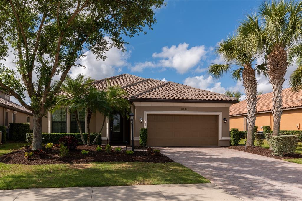 12848 Del Corso Loop Lakewood Ranch, FL 34211 - Photo 45 of 70 a front view of a house with a yard and garage