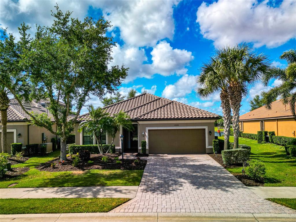 12848 Del Corso Loop Lakewood Ranch, FL 34211 - Photo 57 of 70 a front view of a house with garden