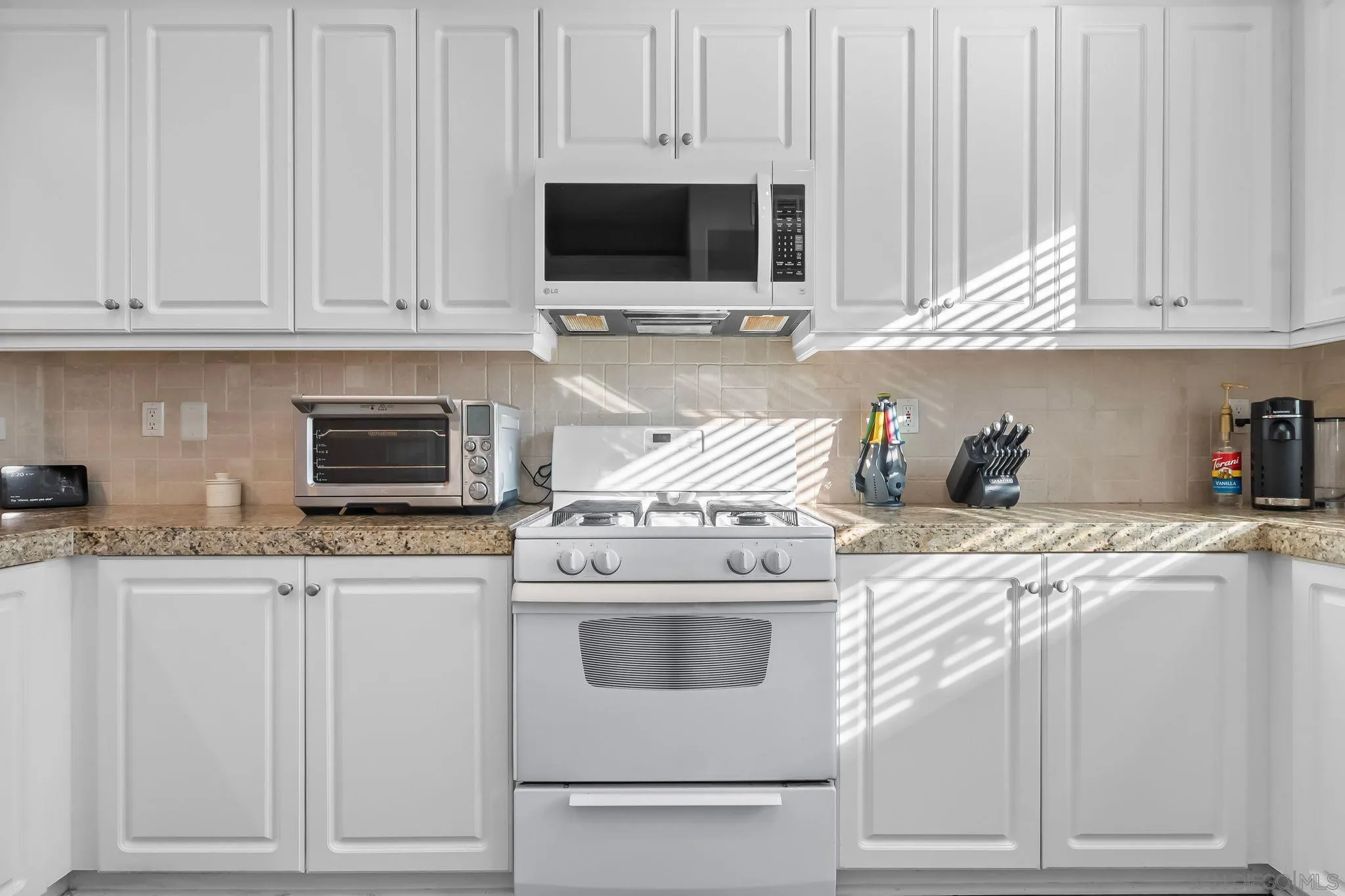 10240 Daybreak Lane, Unit 2 Santee, CA 92071 - Photo 11 of 48 a kitchen with granite countertop white cabinets and white appliances