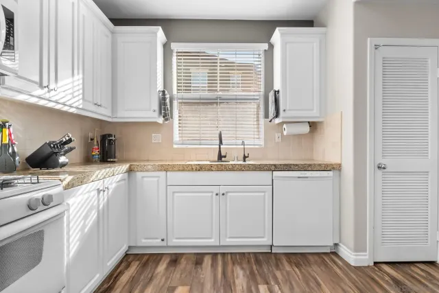a large kitchen with kitchen island a sink stainless steel appliances and cabinets