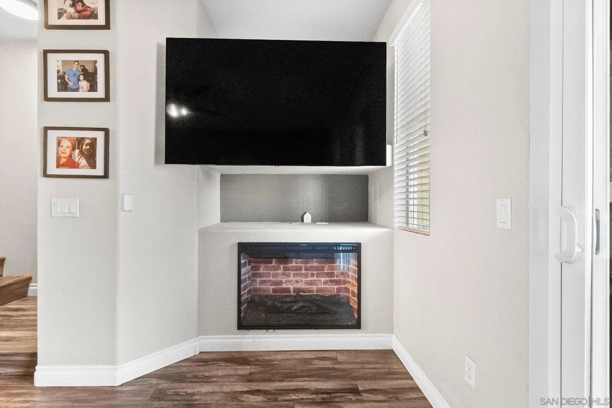 10240 Daybreak Lane, Unit 2 Santee, CA 92071 - Photo 26 of 48 a view of an empty room with wooden floor and a fireplace