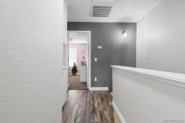 a view of hallway with wooden floor