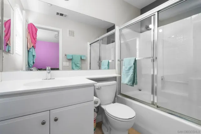 a bathroom with a shower and a sink