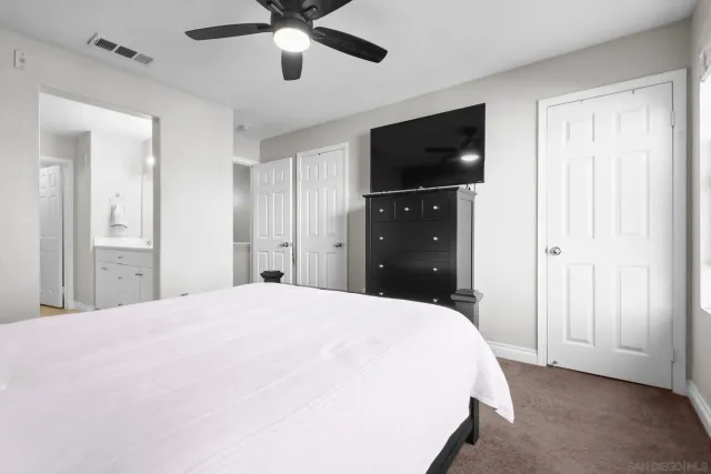 a bedroom with a bed and a large window