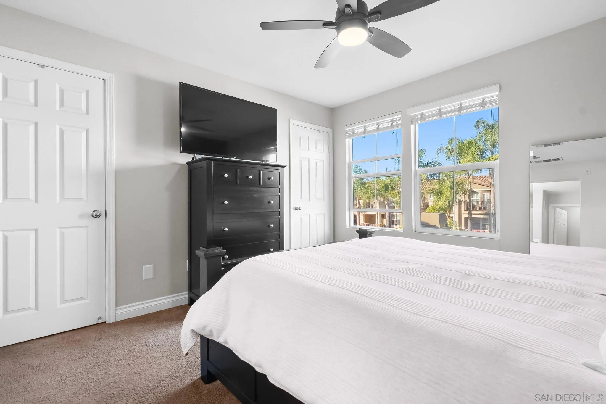 10240 Daybreak Lane, Unit 2 Santee, CA 92071 - Photo 40 of 48 a spacious bedroom with a bed and a flat tv screen on dresser