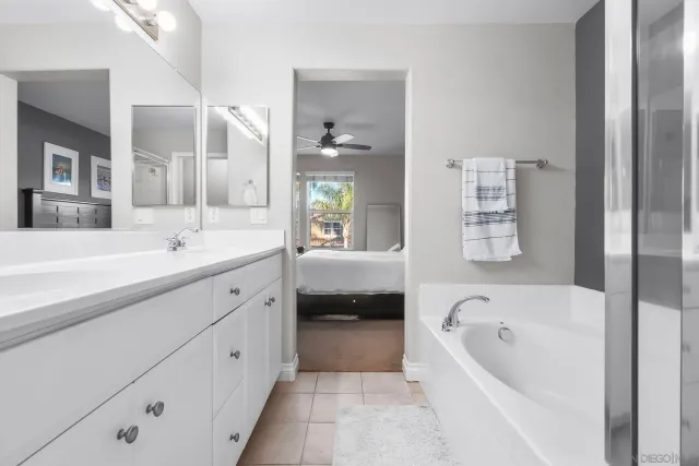 a en suite bathroom with a shower sink and mirror