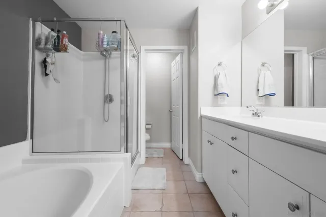 a bathroom with double sink and a mirror