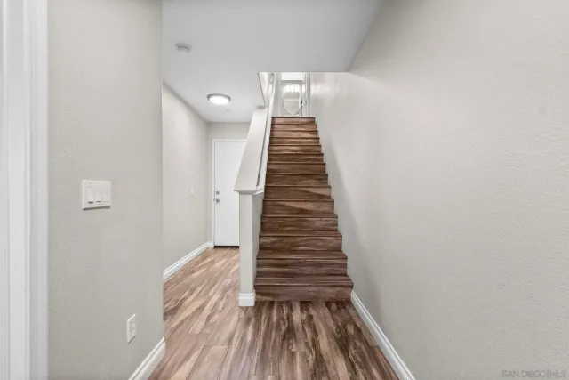 a hallway with a computer on a desk and chair