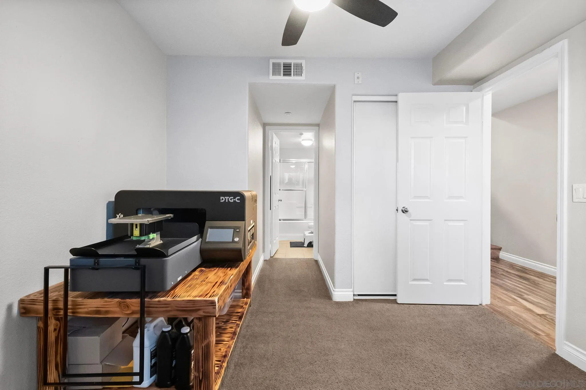 10240 Daybreak Lane, Unit 2 Santee, CA 92071 - Photo 7 of 48 a hallway with a computer on a desk and chair