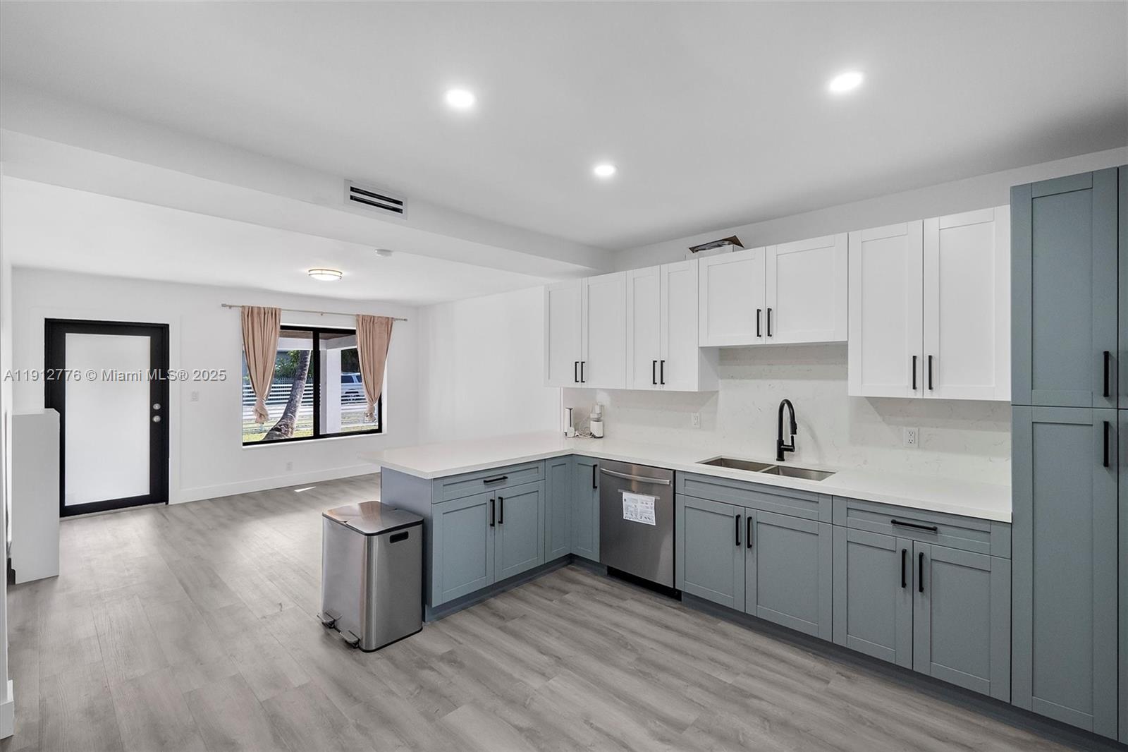 11730 Northwest 3rd Avenue Miami, FL 33168 - Photo 11 of 22 a kitchen with sink cabinets and wooden floor
