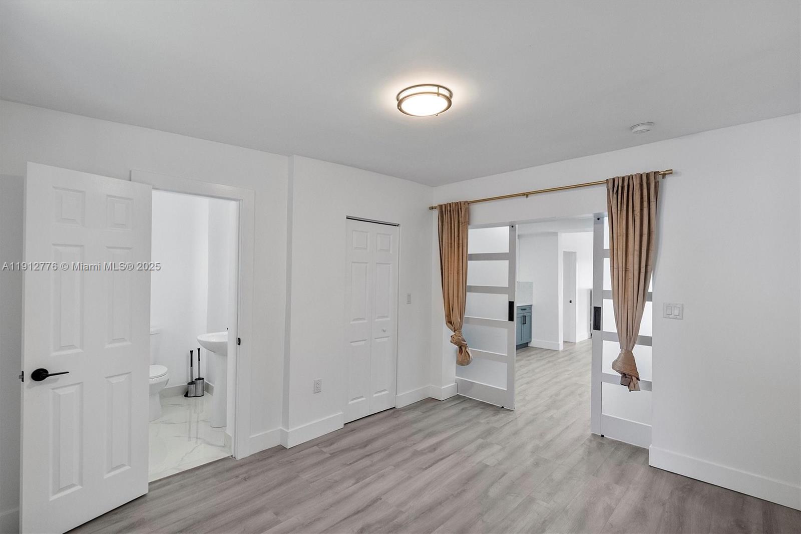 11730 Northwest 3rd Avenue Miami, FL 33168 - Photo 16 of 22 wooden floor in an empty room