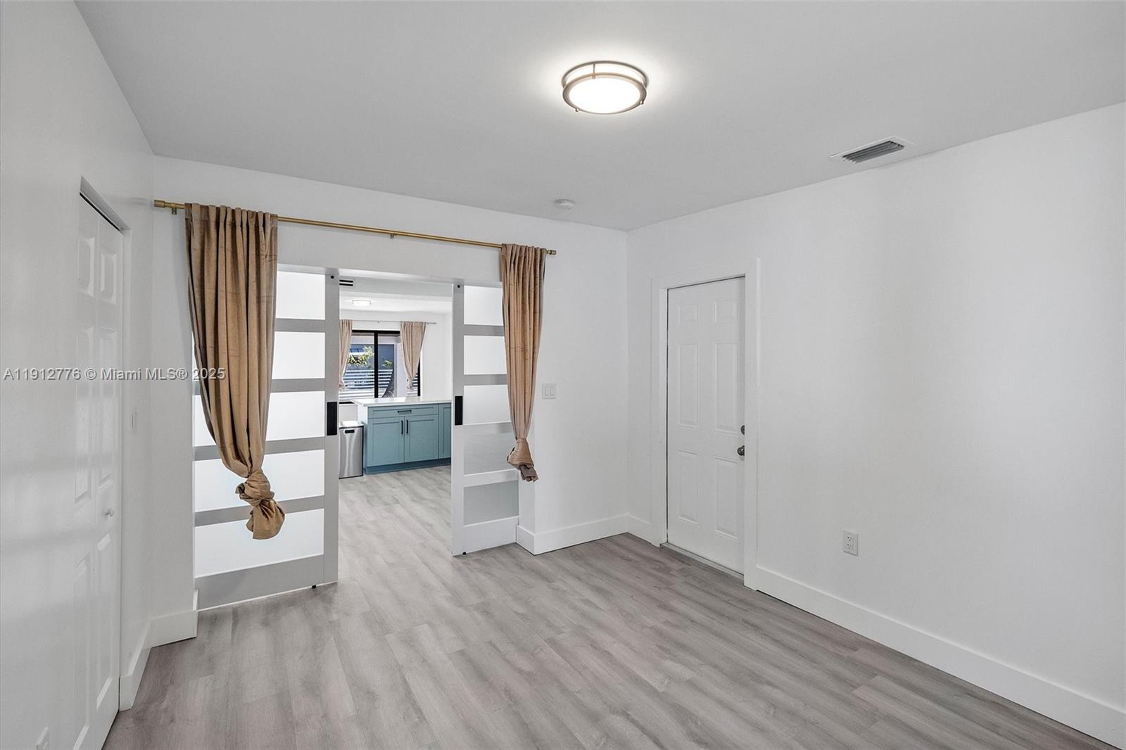 11730 Northwest 3rd Avenue Miami, FL 33168 - Photo 17 of 22 wooden floor in an empty room with a window