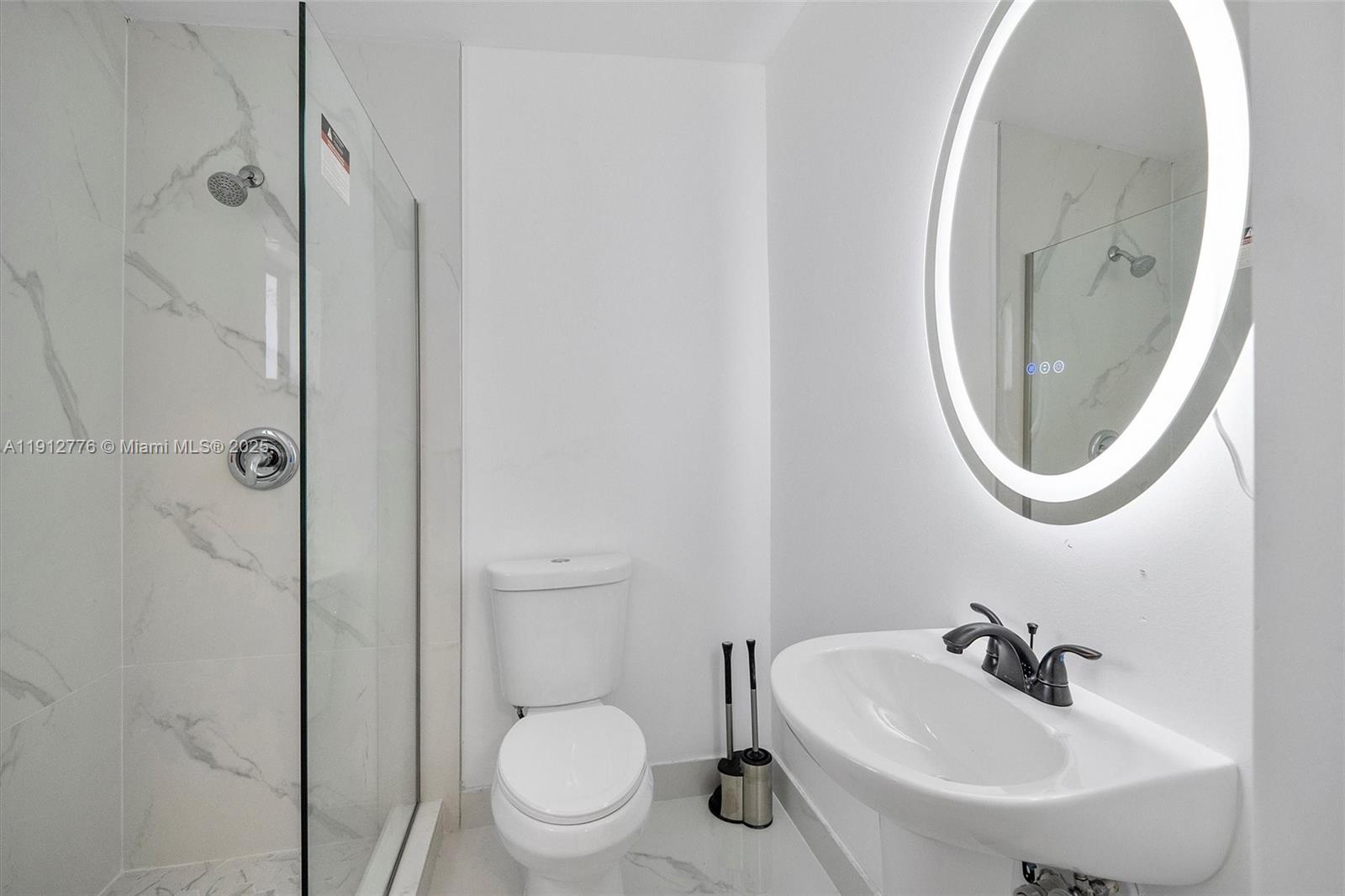 11730 Northwest 3rd Avenue Miami, FL 33168 - Photo 18 of 22 a bathroom with a sink a mirror a toilet and a shower