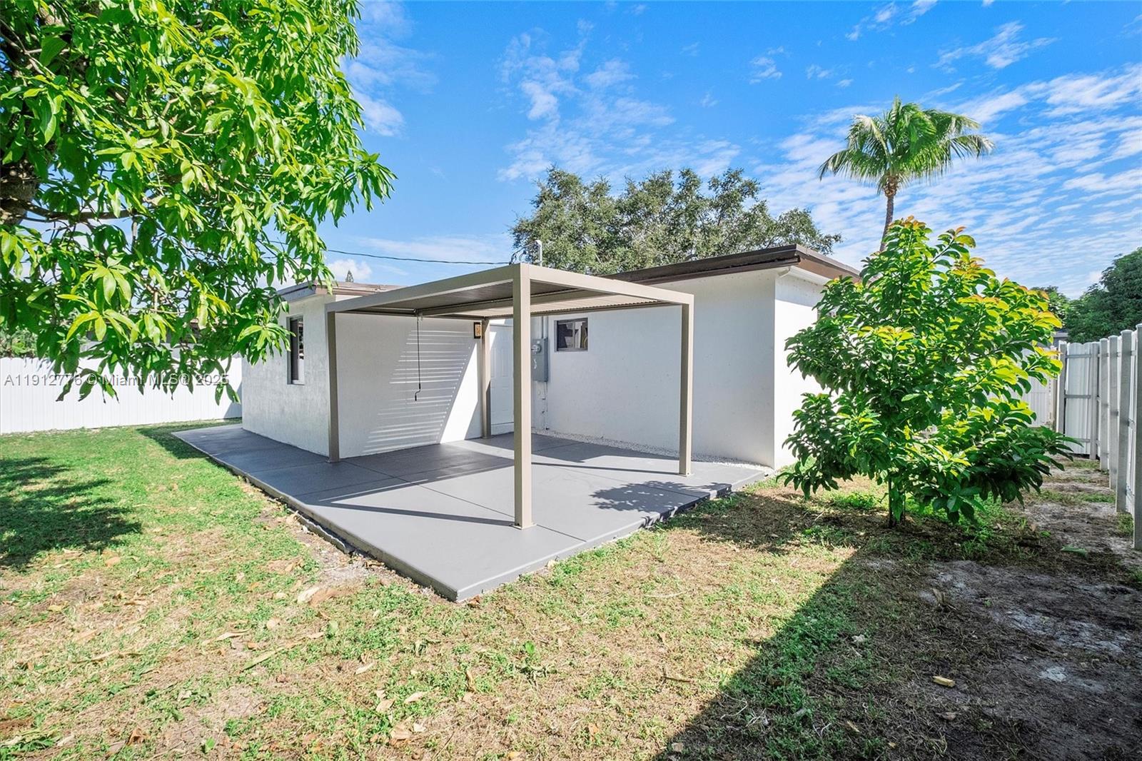 11730 Northwest 3rd Avenue Miami, FL 33168 - Photo 19 of 22 a front view of a house with a yard and garage