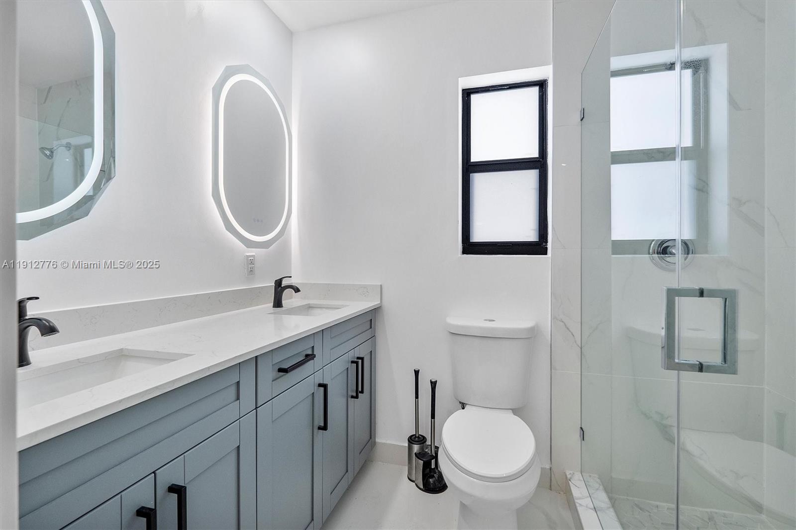 11730 Northwest 3rd Avenue Miami, FL 33168 - Photo 5 of 22 a bathroom with a toilet a sink a mirror and a window