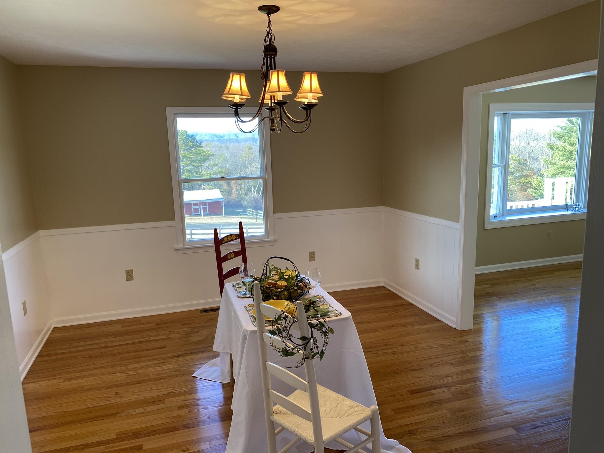 611 Stover Shop Road Churchville, VA 24421 - Photo 21 of 71 a view of a room with wooden floor windows and a chandelier