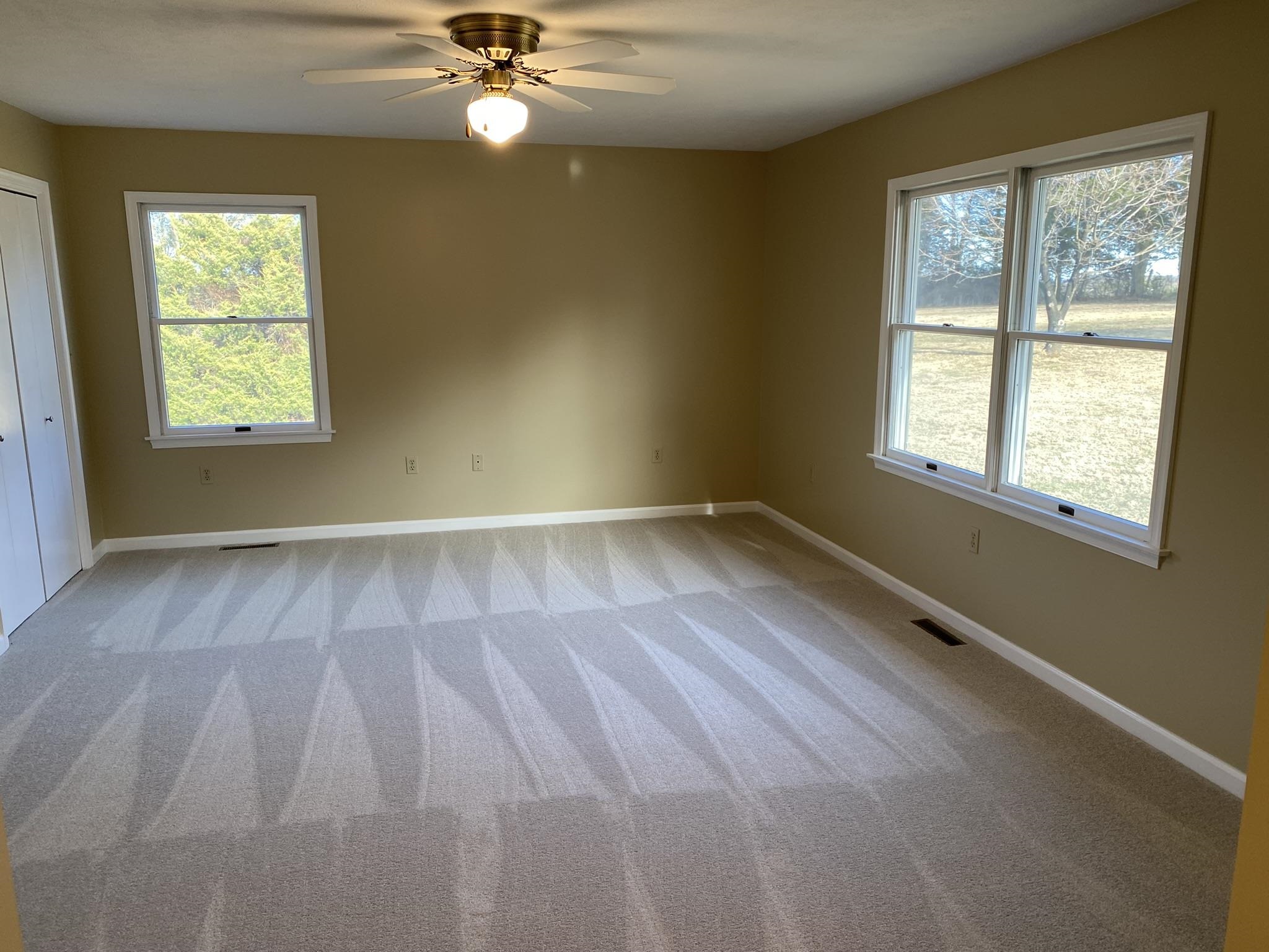 611 Stover Shop Road Churchville, VA 24421 - Photo 35 of 71 an empty room with wooden floor fan and windows