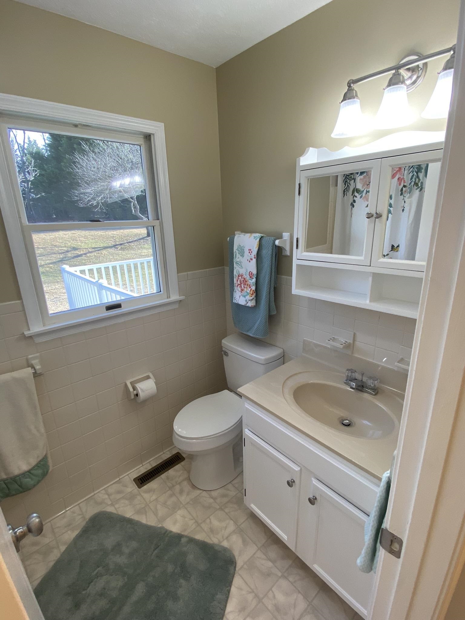 611 Stover Shop Road Churchville, VA 24421 - Photo 38 of 71 a bath room with a toilet a sink and a mirror