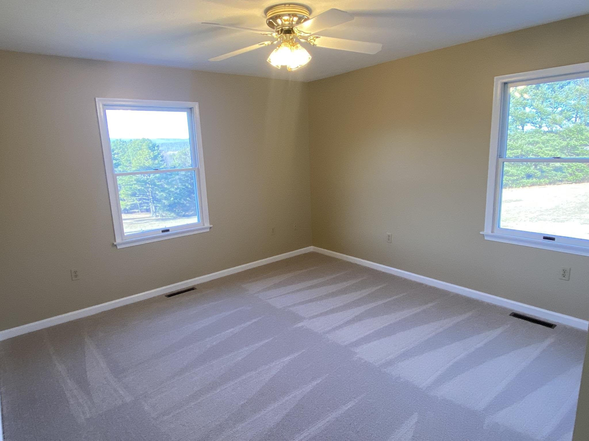 611 Stover Shop Road Churchville, VA 24421 - Photo 40 of 71 a view of an empty room with wooden floor and a window