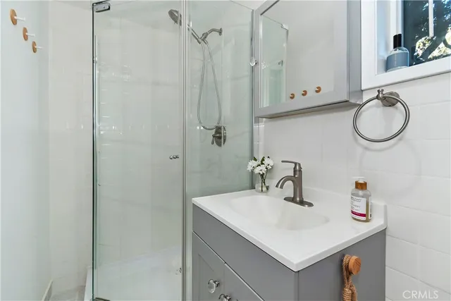 a bathroom with a sink vanity and a mirror